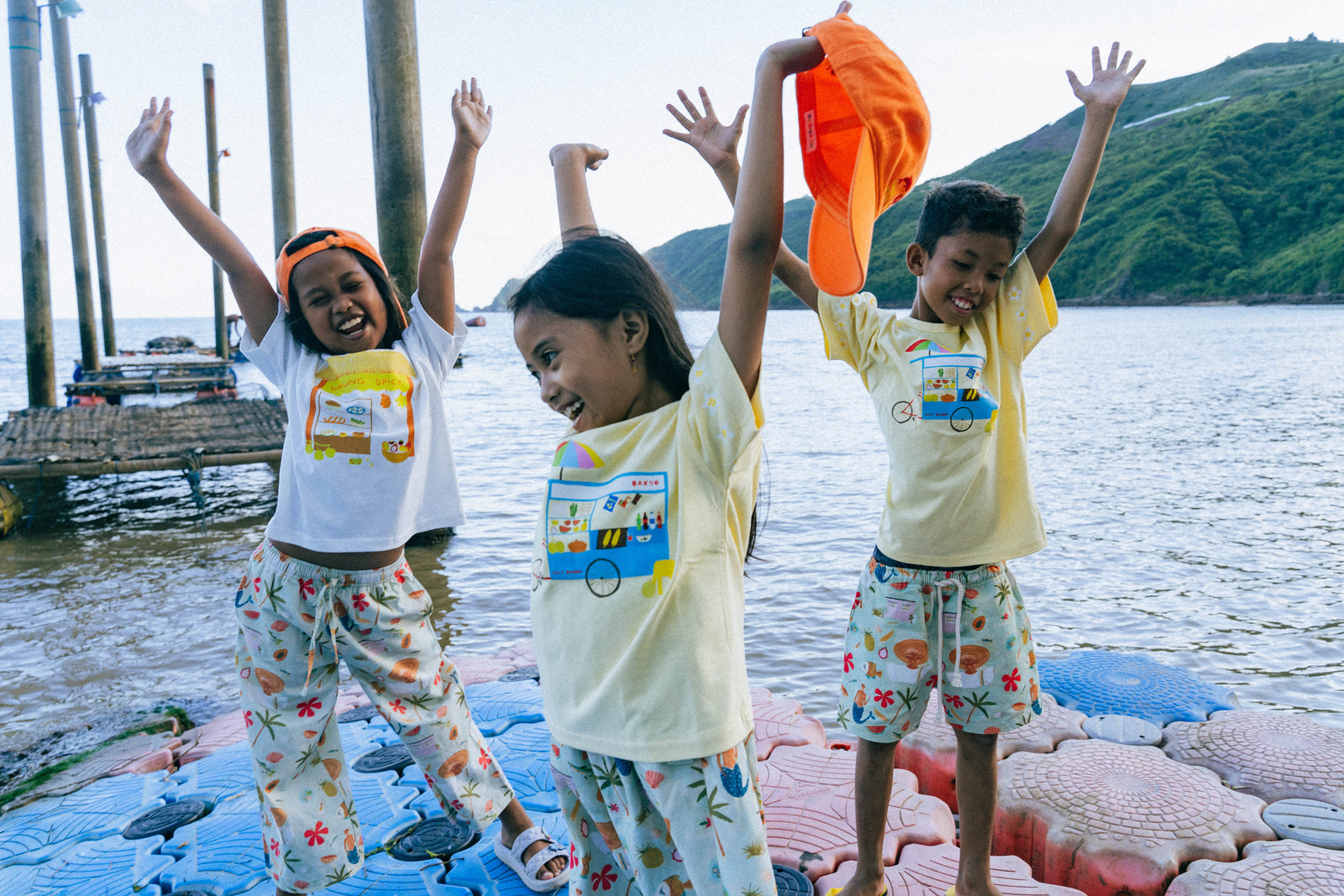Kids wearing the Spicy Dugong reef print at the beach